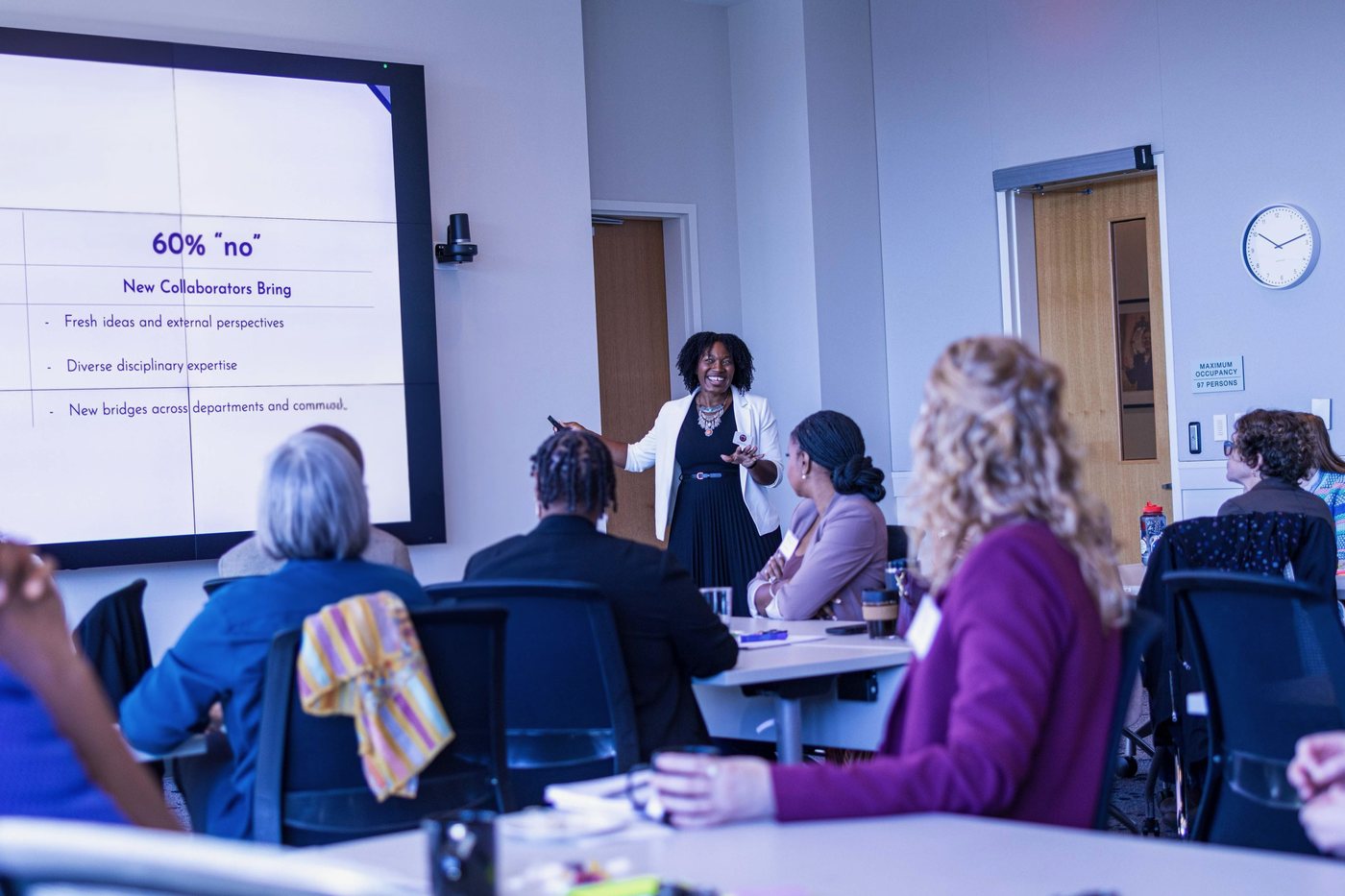 Christina L. Scott facilitating a working session, presenting to a seated group